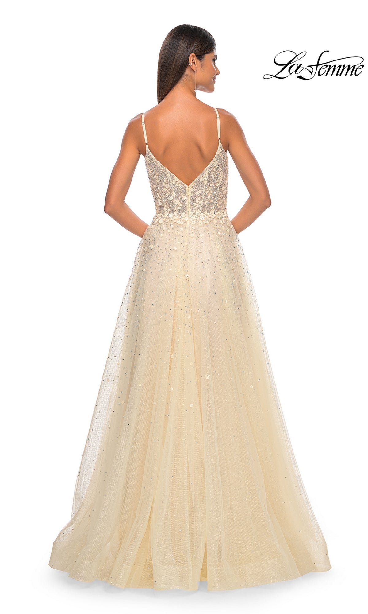A woman is seen from behind in a sleeveless, floor-length light yellow La Femme Embellished Long A-Line Prom Dress 32215 with a V-back and sparkling accents. The La Femme logo is displayed in the top right corner.